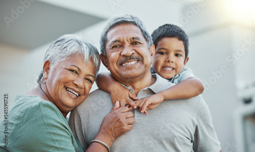 Grandpa, grandma and child hug with smile for happy holiday or weekend break with grandparents at the house. Portrait of elderly people holding grandchild on back for fun playful summer together