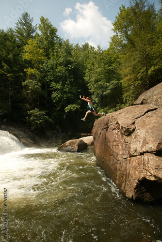 Jennifer Foster leaps into the pool below Turtleback Falls on the Whitewater River near Cashiers, NC.
