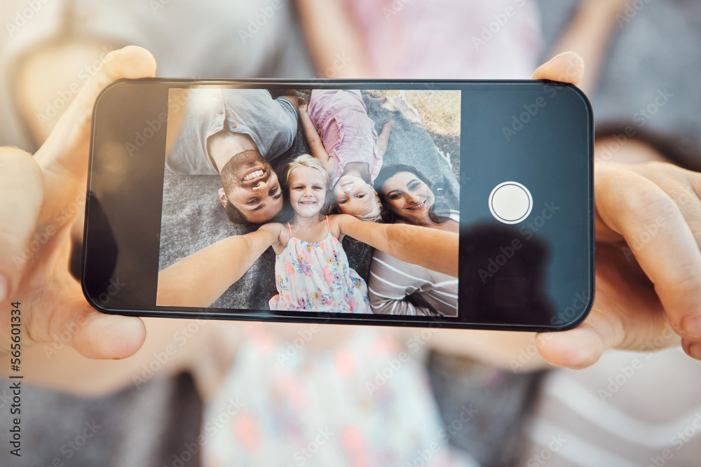 Phone screen, hands and family selfie portrait of hand with mobile zoom and smile on ground. Children, parents and happy together with love and care using a cellphone photo with kids on holiday