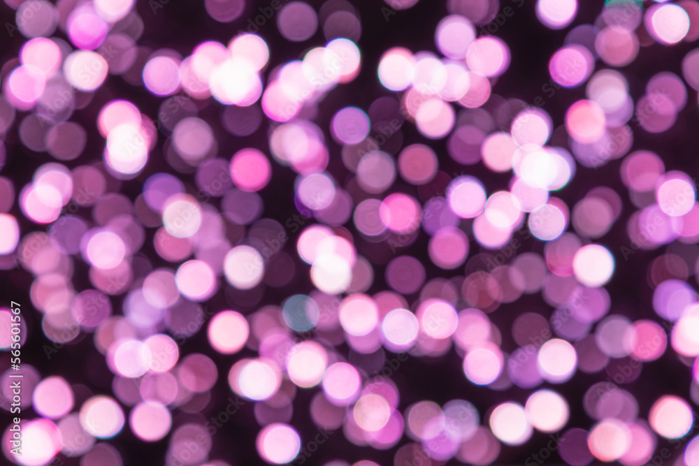 Many taffy color blurred circle of lights on a dark purple background (strong bokeh effect)