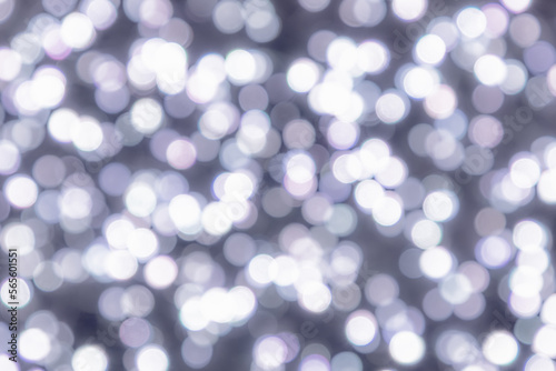 Light gray and white circles of lights on a pale gray background with bokeh effect