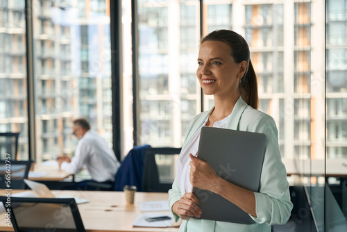 Ambitious lady at office smiling and anticipating career growth