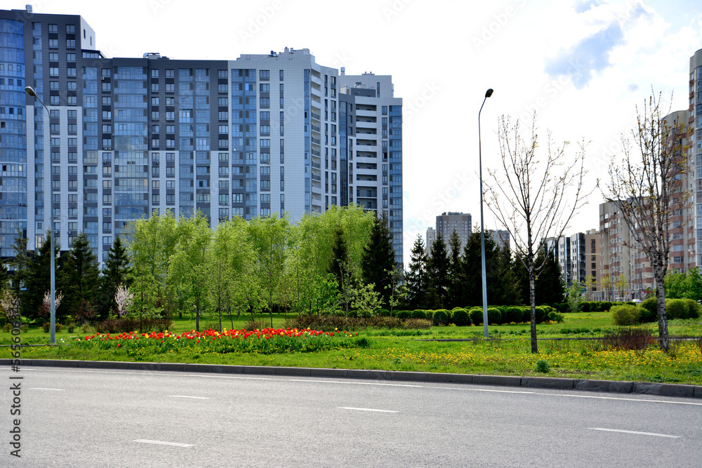 Kazan city with skyscrapers, green park, flowerbed and concrete road