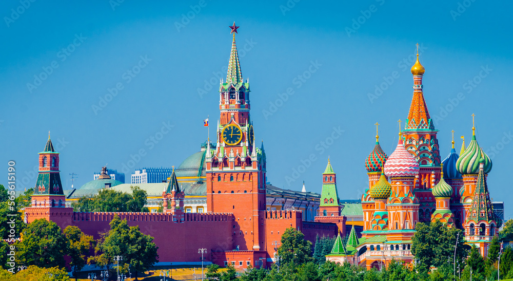 Spasskaya Tower of Moscow Kremlin and Cathedral of Vasily the Blessed (Saint Basil's Cathedral) on Red Square in summer day. Panoramic view. Moscow. Russia Spasskaya Tower of Moscow Kremlin and Cathedral of Vasily the Blessed (Saint Basil's Cathedral) on Red Square in summer day. Panoramic view. Moscow. Russia