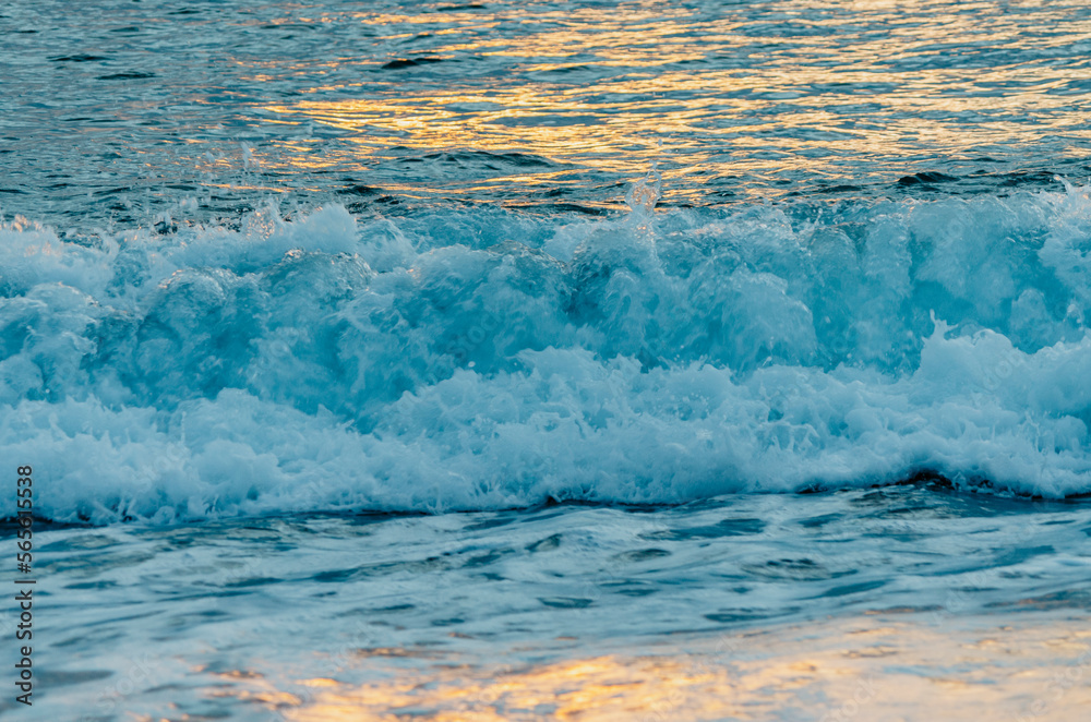 Fototapeta premium Sea waves texture with sunrise light reflection