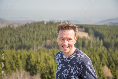 caucasian man posing on top of the Ottofelsen rock in Germany © Dirk