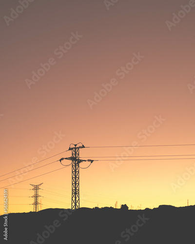  A minimalistic view of powerlines at a fiery red sunset, going in various different directions