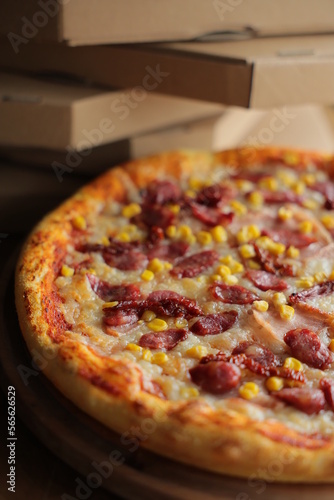 pizza with corn, mozzarella, sausage and meat. Pizza with boxes
