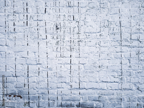 Vector texture of an old dirty brick wall painted white. Original illustration with damage and streaks of black resin for the designer. Close-up of a wall of carelessly laid bricks