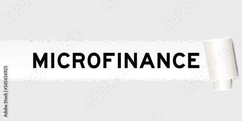 Ripped gray paper background that have word microfinance under torn part