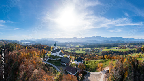 Sternberg church and idyllic graveyard in Wernberg  Carinthia  Austria during autumn with a view to Lake W  rthersee in the background.
