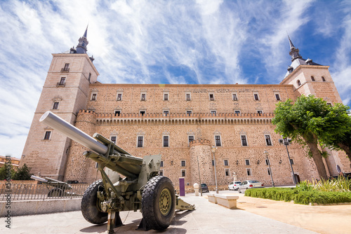 Cannon in the foreground with the walls and towers of the Alcazar of Toledo behind it