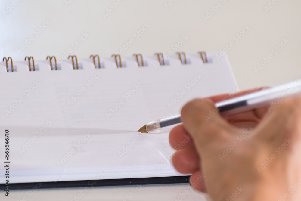 person writing in a blank notebook, planning person writing in a blank notebook, planning