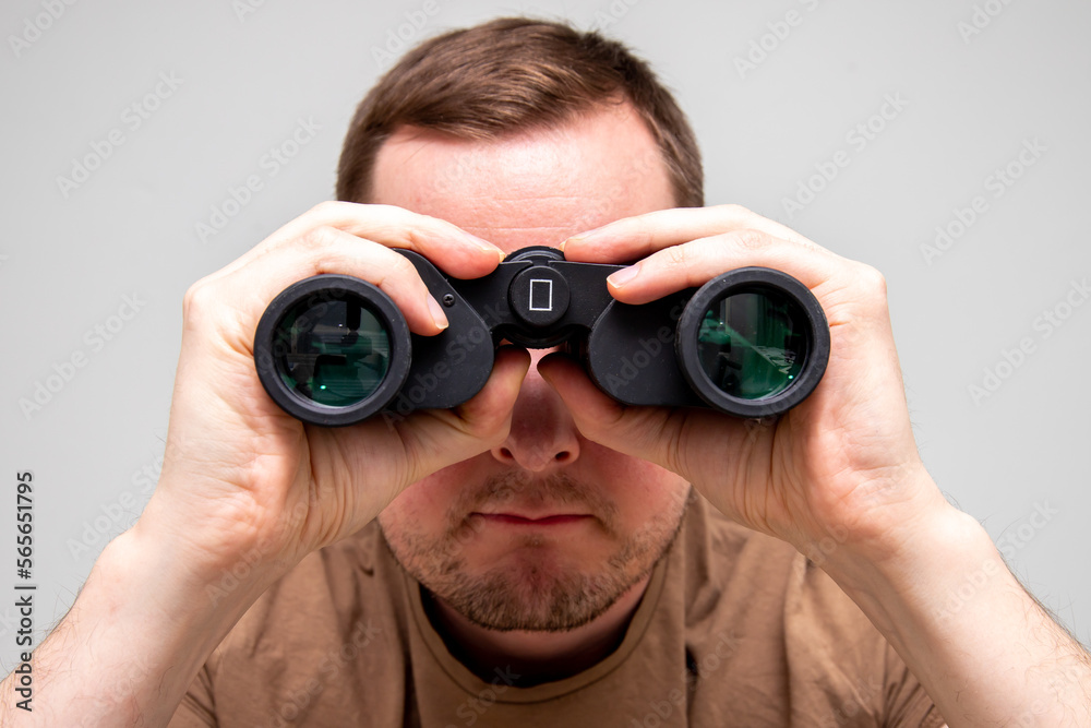 Man watching you through binoculars Man watching you through binoculars