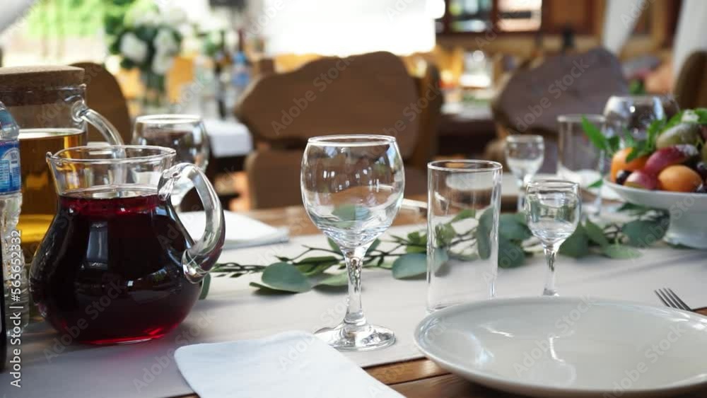beautifully set table with glasses and other dishes at the banquet waiting for guests beautifully set table with glasses and other dishes at the banquet waiting for guests