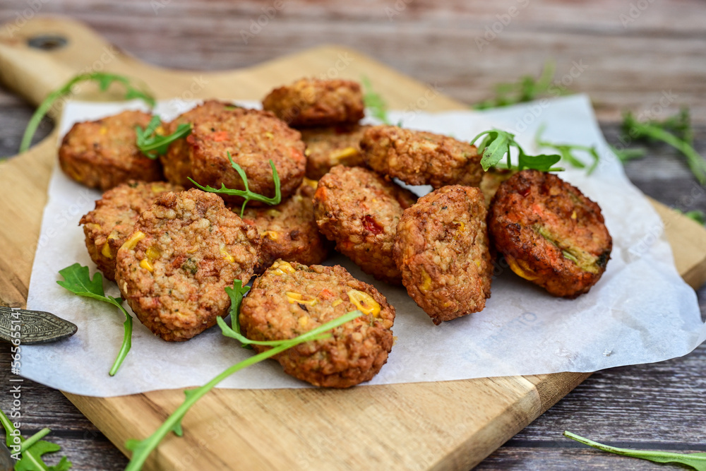 Home made oven baked mini Chicken and vegetable meatballs on wooden background Home made oven baked mini Chicken and vegetable meatballs on wooden background