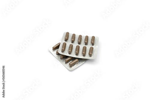 Two aluminum foil-covered blister packs with brown tablets isolated on a white background