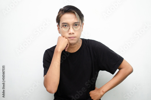 Thoughtful asian man in peek a boo hair hinking and wondering with hand touching skin as thinking gesture isolated over white background photo