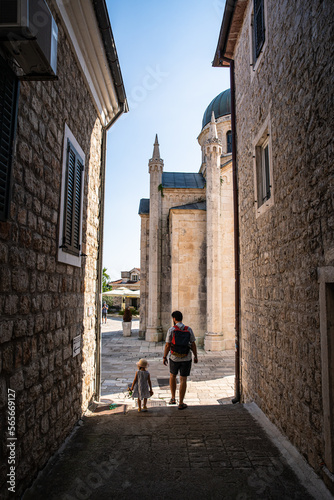 Father and little daughter walking on narrow streets of Mediterranean town. Herceg Novi, Montenegro. © Sofiia.Popovych