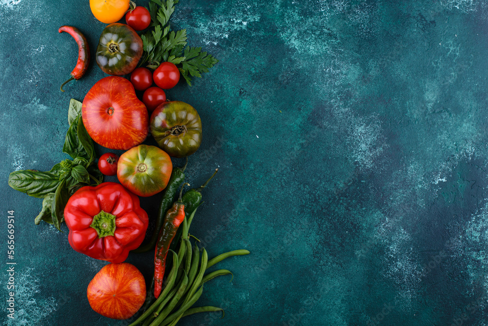 Assortment of different tomatoes, pepper and basil