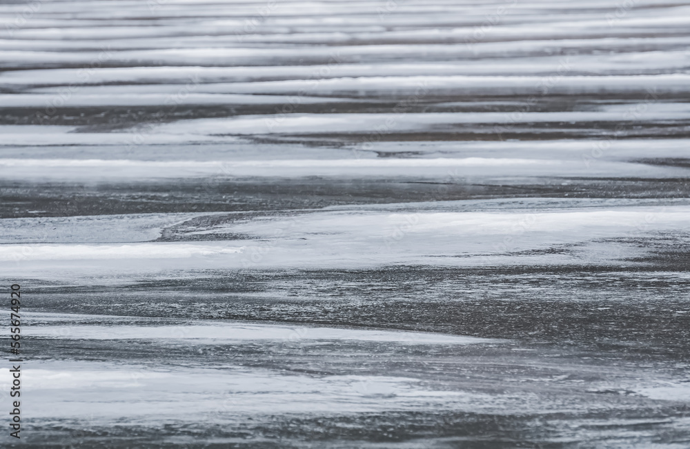 Texture of an icy lake in winter with snow and ice in macro, winter cloudy day Texture of an icy lake in winter with snow and ice in macro, winter cloudy day