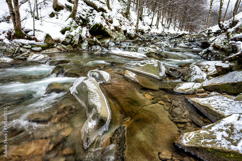 Mountain stream in winter scenery. Prowcza Stream, Bieszczady National Park, Carpathian Mountains, Poland. One of the most popular travel destinations in Poland. photo
