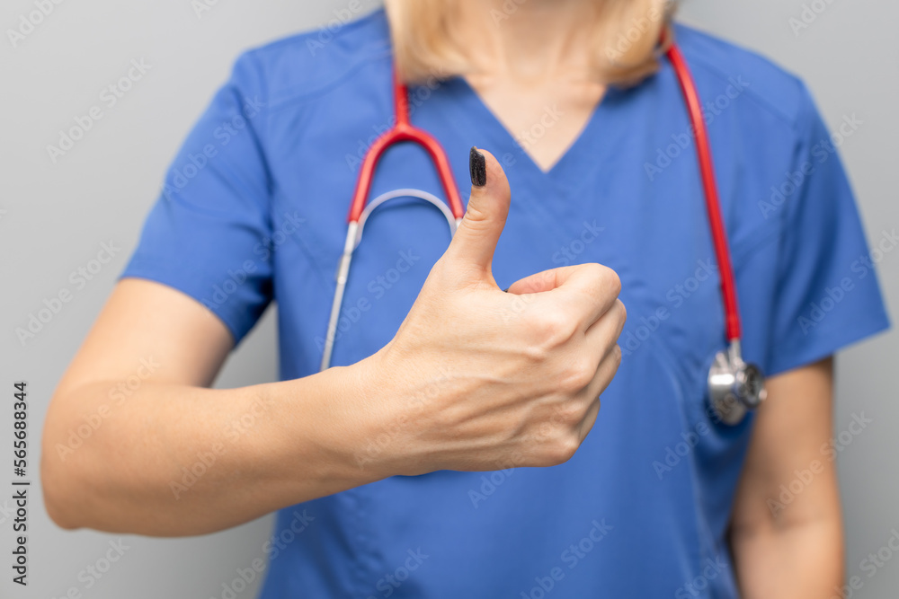 doctor in uniform in hospital holding thumb up doctor in uniform in hospital holding thumb up