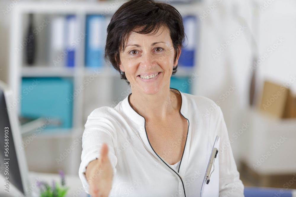 a happy woman during business handshake a happy woman during business handshake