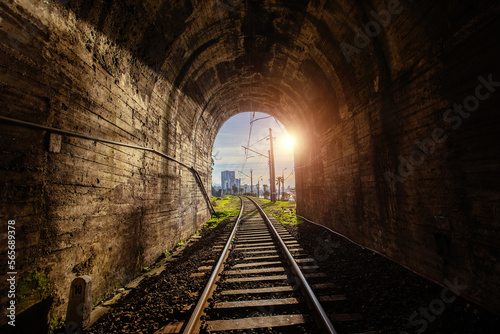 Sunset light at the end of railroad tunnel