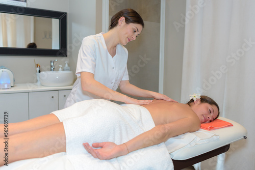 professional masseuse massaging womans back
