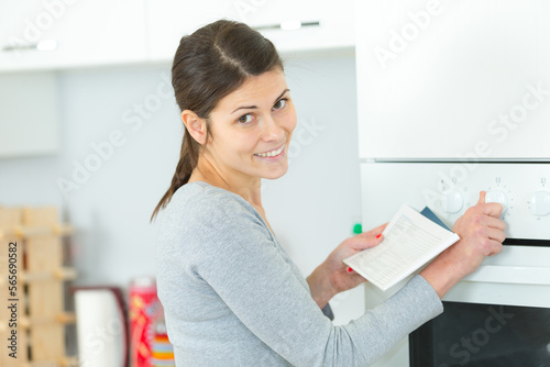 woman setting the kitchen oven