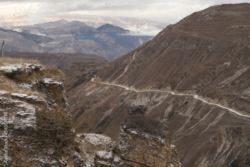 Scenic panorama: foggy mountains, cloudy sky and undulating slopes on a winter day in Dagestan.