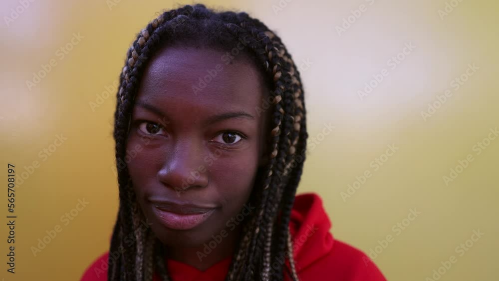 young african woman with dreadlocks looks at camera smiling yellow background young african woman with dreadlocks looks at camera smiling yellow background