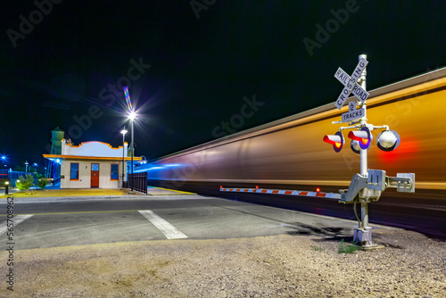 train passes at railroad crossing in the night. The Kingman station of the Santa Fee railroad opened in 1907 and is still in use