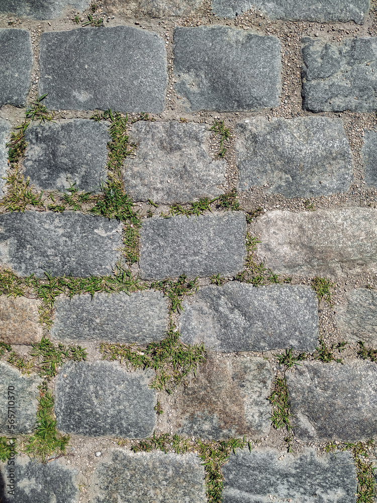 Texture of dark gray granite paving stones, top view. Background from natural block stone. Texture of dark gray granite paving stones, top view. Background from natural block stone.