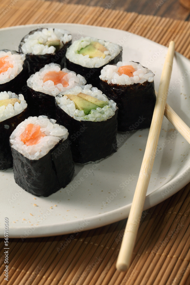 Sushi roll plate with avocado and salmon makis Sushi roll plate with avocado and salmon makis
