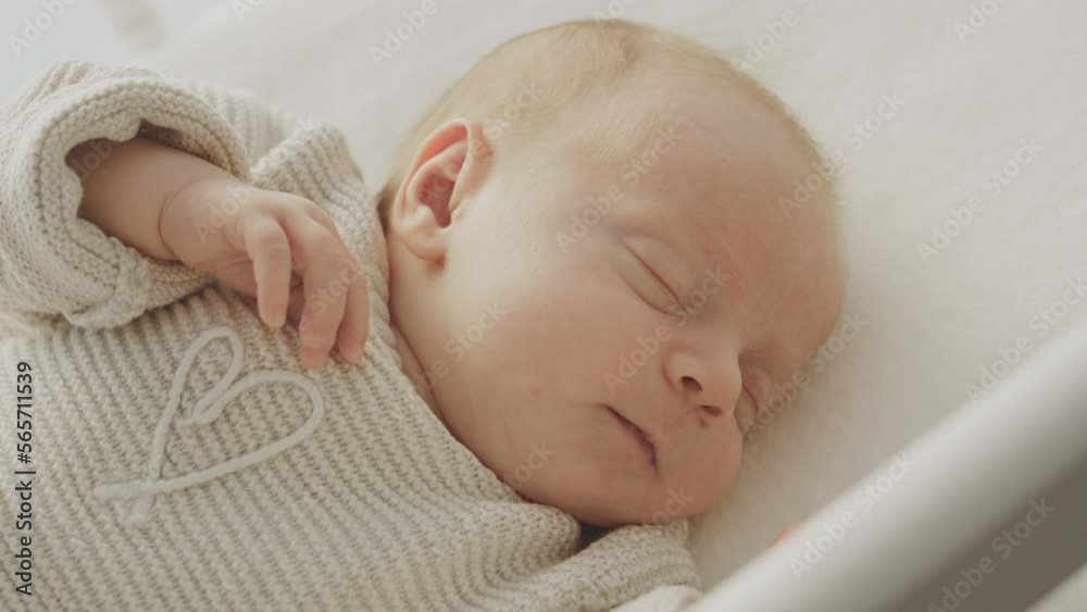 Close-up shot of a cute newborn baby sleeping in swinging cradle. Happy family concept Close-up shot of a cute newborn baby sleeping in swinging cradle. Happy family concept