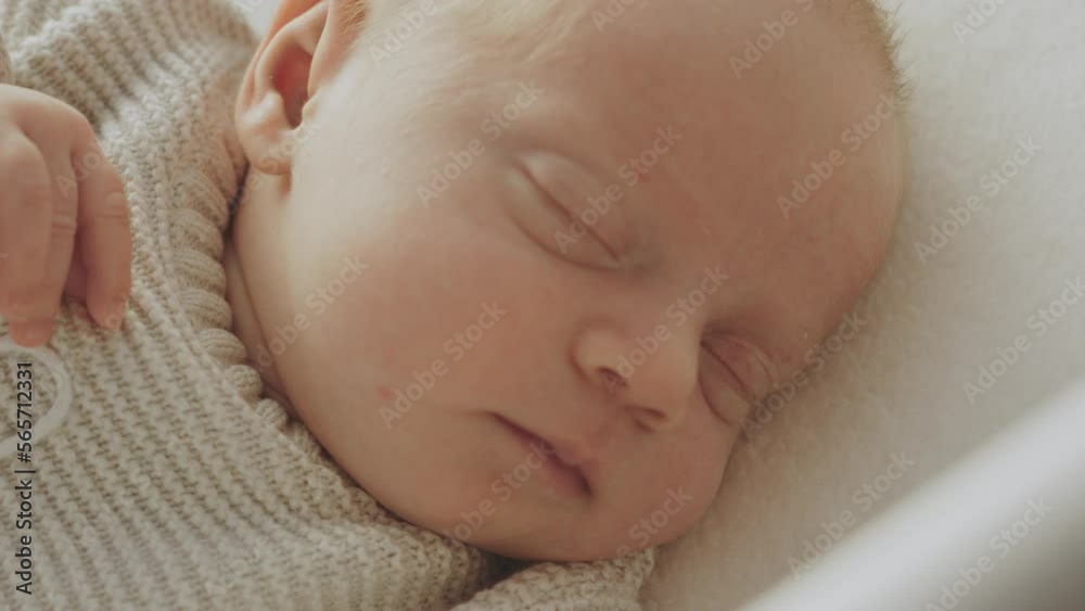 Adorable little child sleeping in white wooden crib at home. Focusing on sleeping baby's hand Adorable little child sleeping in white wooden crib at home. Focusing on sleeping baby's hand