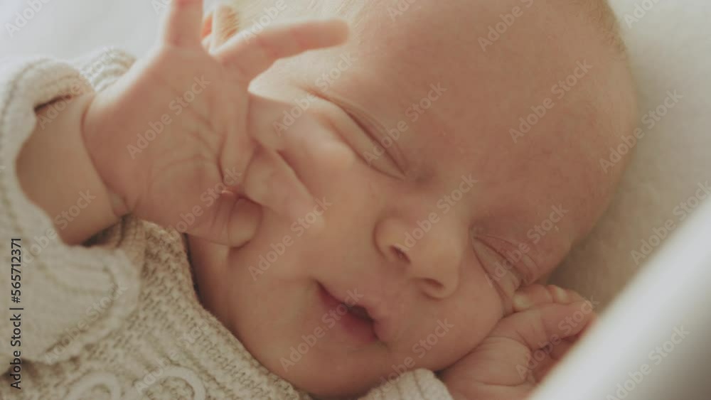 Infant waking up from his sleep, moving and strethcing his hands in slow-motion Infant waking up from his sleep, moving and strethcing his hands in slow-motion