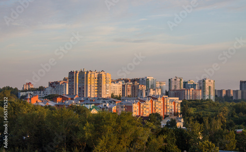 Panoramic top view of the modern houses of the residential area of the city of Vladimir in Russia and a park with lush green foliage of trees on a sunny summer morning