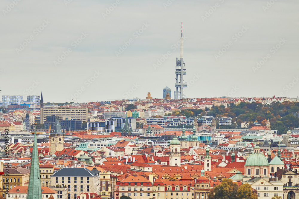 Zizkov Tower television in Prague in autumn. Traditional tile rooftops in foreground.