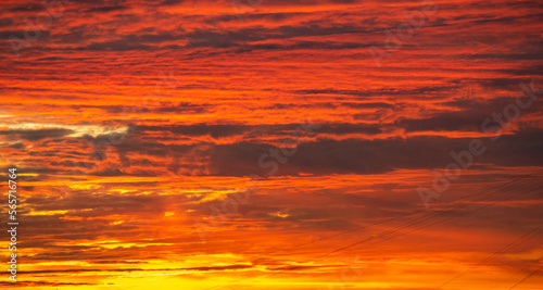 Red clouds in the morning sky in the rays of the rising sun. Sunrise.