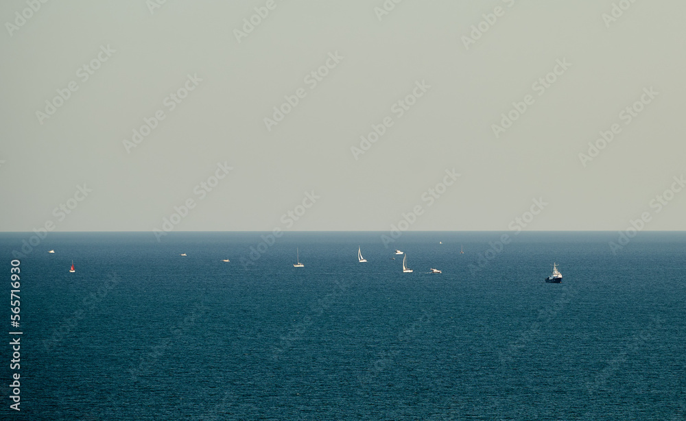 Sailboats and yachts in the open sea during the calm