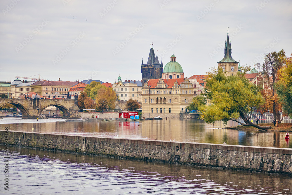 Obraz premium The Bedrich Smetana Museum in Prague in autumn. View from the other side of the river Vltava.