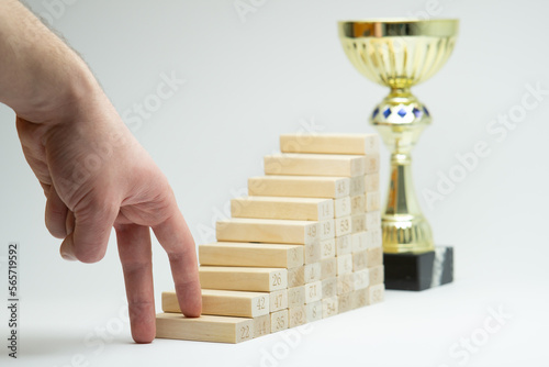 Human hand climbing stairs on white background, concept for growth in life. Career ladder. Professional development, aims achievement, path to prosperity, hard path to award. Making the first step.