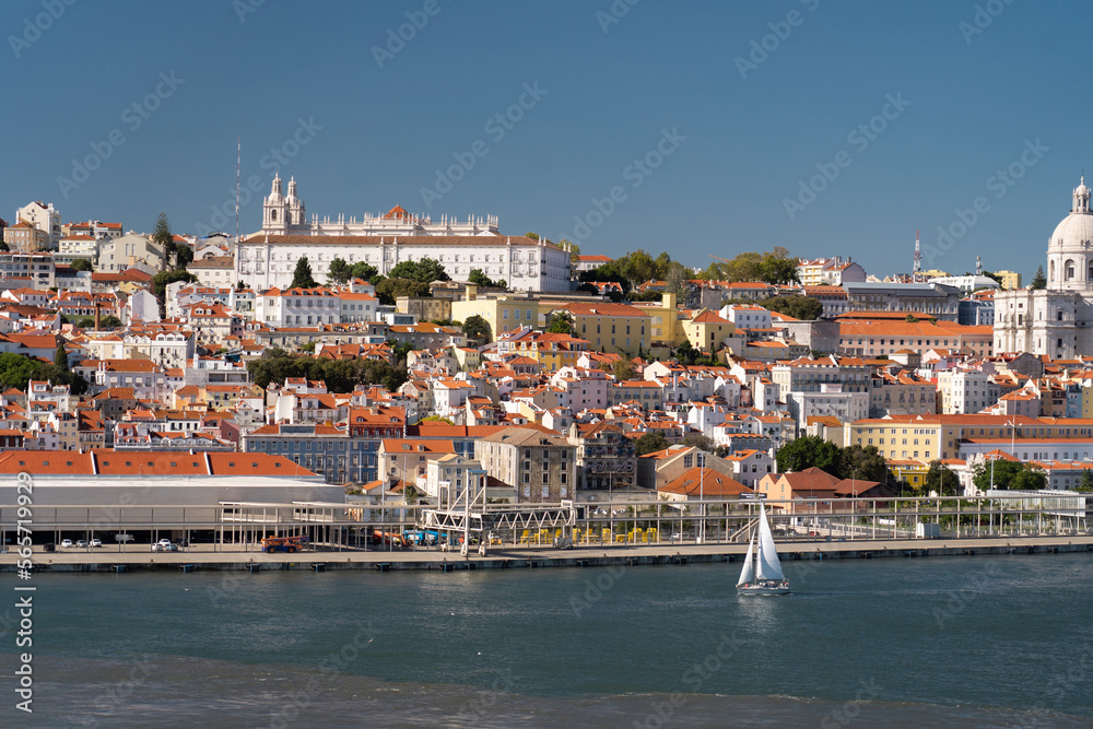 Lisbon, Portugal skyline of waterfront on Tagus River with sailboat. Vacation and travel concept