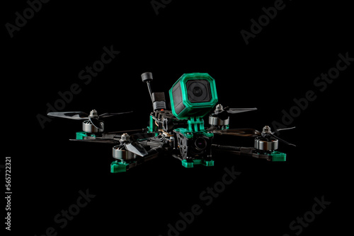 Fototapeta Naklejka Na Ścianę i Meble -  Modern FPV drone. Four-engine aircraft on the radio control. Drone for racing, filming and entertainment. Dark back.