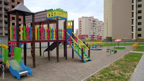 Wallpaper Mural Beautiful colorful children’s playground with ladders, slides and teeterboards. Multi-storied building being constructed at backdrop. Torontodigital.ca
