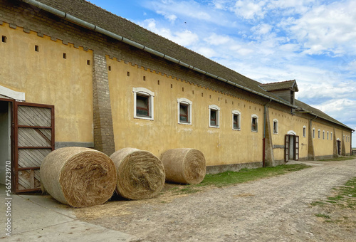 Old Horse Barns & Wagons. Horses & Magyar cowboys perform at Hungarian horse show on ranch near Kalocsa, Hungary. The village is  ⁨‎⁨Dunapataj⁩, ⁨Bács-Kiskun⁩, ⁨Hungary, 60 miles south of Budapest.  photo