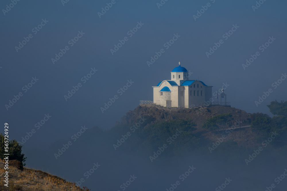 Church on top of mountain, surrounded by fog